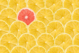 Fototapeta Perspektywa 3d - One Pink Grapefruit Slice Stand Out Of Yellow Lemon Slices