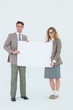 © WavebreakmediaMicro - Hipster couple holding poster smiling at camera