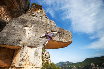 Wall Mural - Woman climber on a cliff