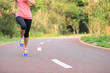 © lzf - young fitness woman legs running at forest trail