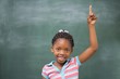 © WavebreakMediaMicro - Pupils raising hand in classroom