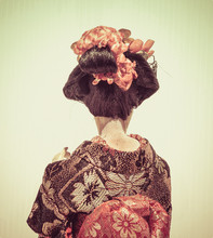 Backside Of Japanese Traditional Doll Of Dancing Geisha With Whi