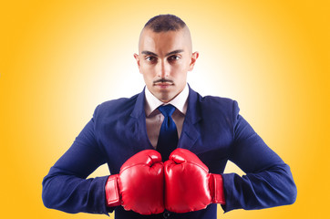 Wall Mural - Handsome businessman with boxing gloves