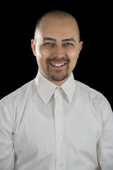 happy young man smiling at the camera isolated on black backgrou