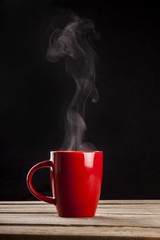 Canvas Print - Aroma. Steaming coffee cup on dark background