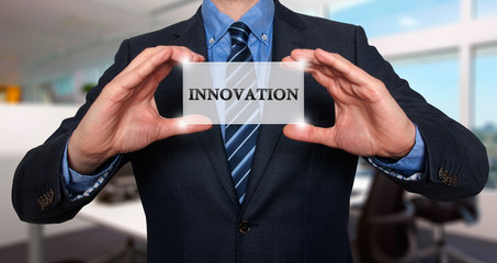 Wall Mural - businessman holding white card with innovation sign