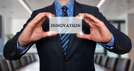 Wall Mural - businessman holding white card with innovation sign