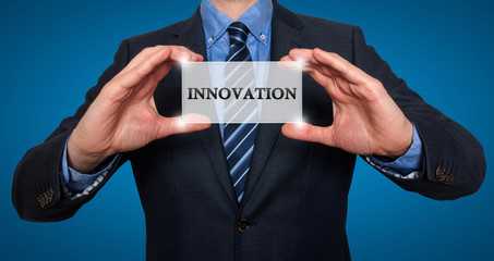 Wall Mural - businessman holding white card with innovation sign