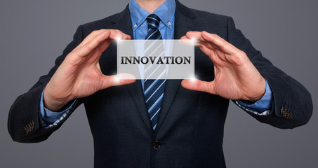 Wall Mural - businessman holding white card with innovation sign