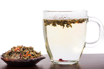 Aromatic antioxidant green tea on wooden board, isolated backgro