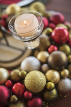 A Table Laid For A Celebration Meal. Christmas Ornaments, Decorations And A Candle In A Candle Holder.  
