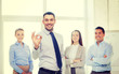 © Syda Productions - smiling businessman showing ok-sign in office