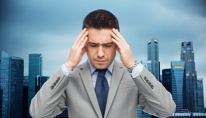 Canvas Print - businessman in suit having head ache