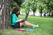 © lexmomot - Colorful Close Up of using tablet in the park.