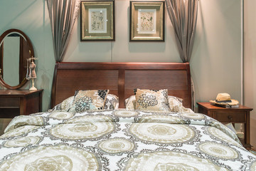 Luxury bedroom furniture. Carved wood bed with pillows and lamps