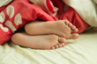 Close up child feet in bed