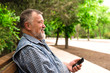 © kostyha - old man with the phone in the park