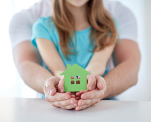 Poster - close up of man and girl hands with paper house