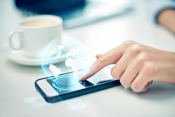 Wall Mural - close up of woman hand with smartphone and globe