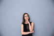© Drobot Dean - Attractive woman with finger over lips looking up at copyspace