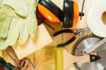 Many working tools on a wooden background.