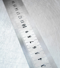 Ruler on the scratched metal background.