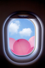 Clouds And Pink Balloons In The Aircraft's Porthole