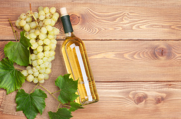 White wine bottle and bunch of white grapes