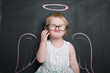 © likuzia - Little girl at the blackboard with wings and halo