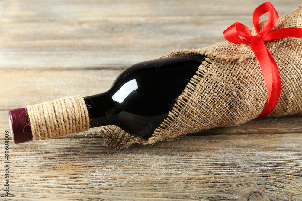Red wine bottle wrapped in burlap cloth