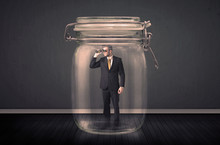 Businessman Trapped Into A Glass Jar Concept