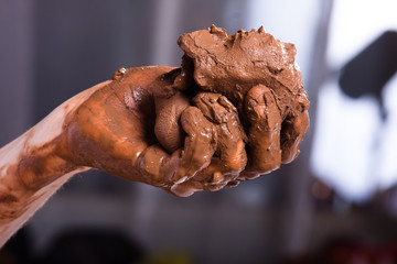 hands of a potter with clay, closeup