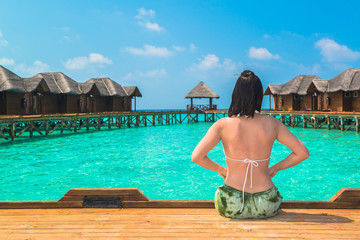 Woman is relaxing at tropical beach, South Male Atoll. Maldives