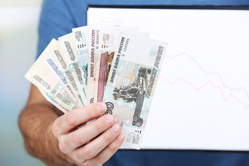 Canvas Print - Man holding money and graph document close up