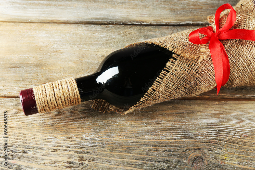 Red wine bottle wrapped in burlap cloth