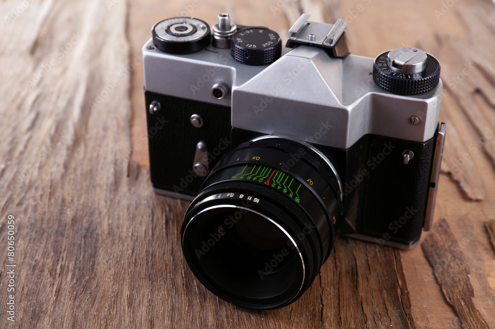 Retro photo camera on wooden background
