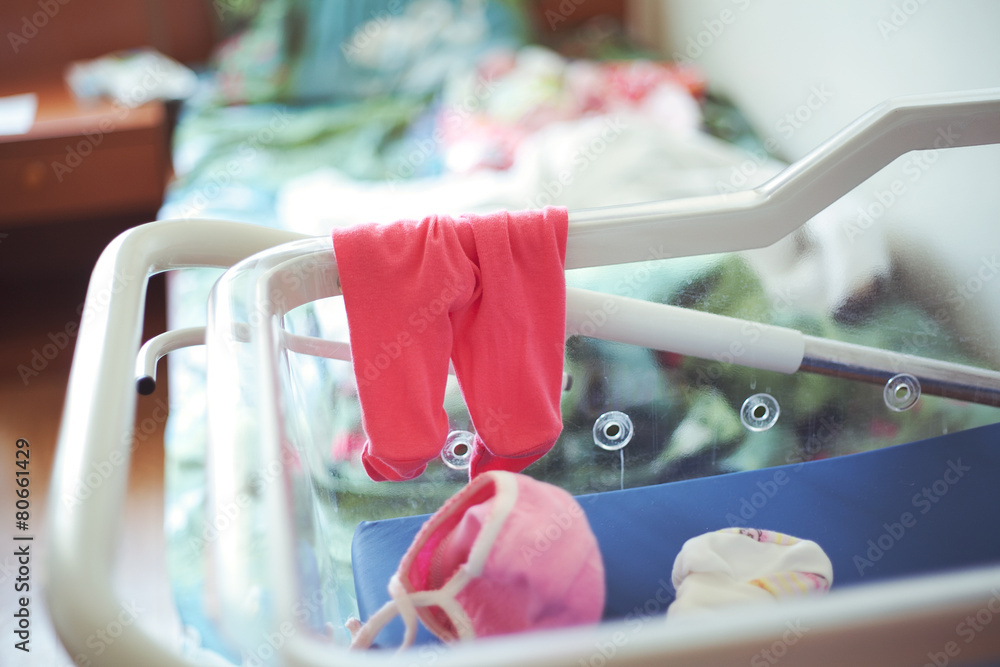 Panties and little baby cap in hospital cradle for newborns