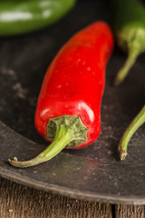 Red and green peppers in vintage retro moody natural lighting se