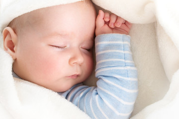 Baby sleeping covered with soft blanket