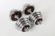 © Pitcher - Chrome dumbbells on the white background.