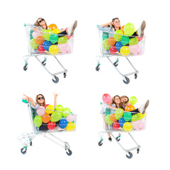 Girl with many balloons inside supermarket cart over white backg