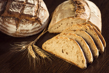 Rustic Bread And Wheat On A Dark Brown Fundal