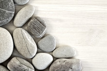 Smooth Pebbles On An Old Wooden Background. Place For Your Text