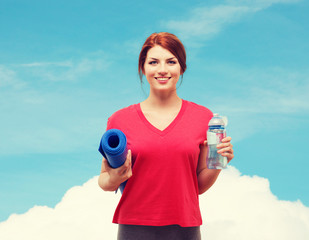 Wall Mural - smiling girl with bottle of water after exercising