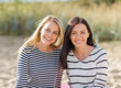 © Syda Productions - happy teenage girls or young women on beach