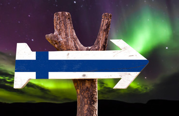 Wall Mural - Finland flag wooden sign with northern lights background