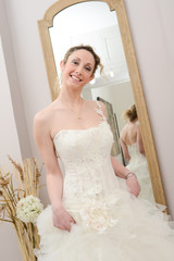Wall Mural - Beautiful young happy bride in a  white and ivory wedding dress
