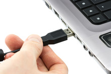 Hand Connecting USB Cable To Laptop Computer