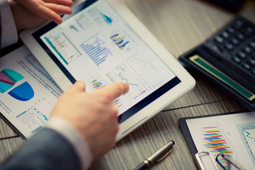 man on online Financial Assessment on a tablet .