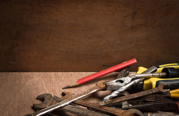 Old tools renovation on grunge wood.